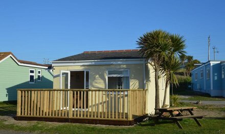 Outdoor decking with views towards St. Ives Bay & comfortable accommodation for up to five guests.