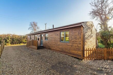 A superb wooden lodge that fits the description of a Norfolk hideaway to a tee