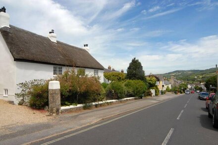 A thatched, 17th century home in a central position within Charmouth.