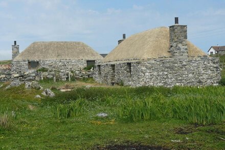 Traditional stone and thatch cottage on the waters edge with beautiful sea views