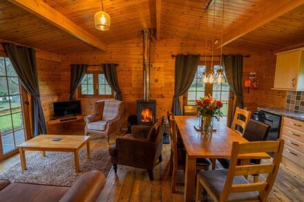 Large three bedroom log cabin with private hot tub and decking over looking the beautiful river Brue