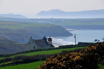 Stunning sea views, idyllic characterful farmhouse with log burner and jacuzzi