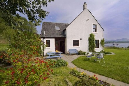 Large cottage  on shore of Scottish Loch