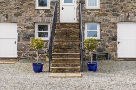 THE OUTBUILDINGS, pet friendly, luxury holiday cottage in Llangaffo