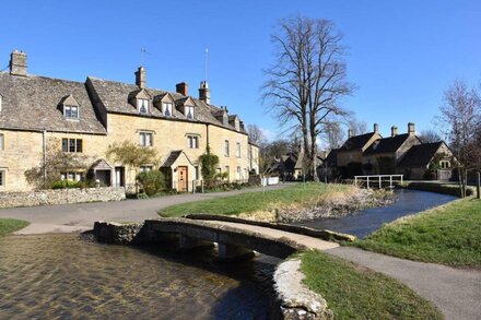 Period cottage in idyllic riverside location in prime Cotswolds village