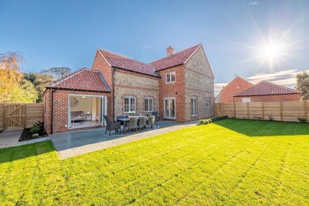 A superb, brick and flint modern detached house set right in the heart of one of Norfolk's most popu