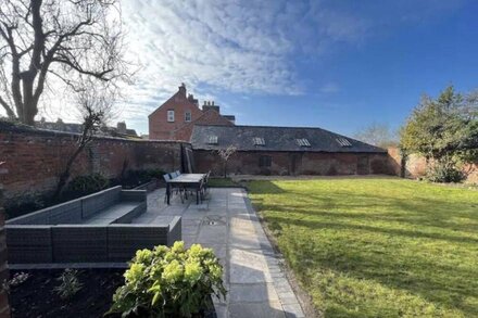 Small house with a quintessentially English walled garden.