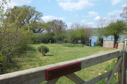 Charming cottage right on the river bank with fabulous views.