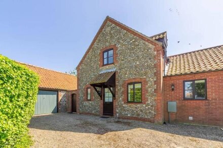 Modern detached house decorated in a low key seaside style