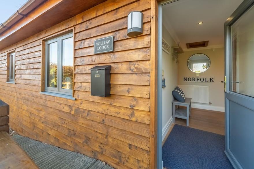 A superb wooden lodge that fits the description of a Norfolk hideaway to a tee