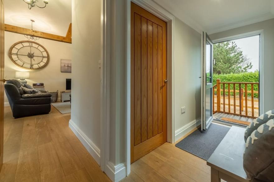A superb wooden lodge that fits the description of a Norfolk hideaway to a tee