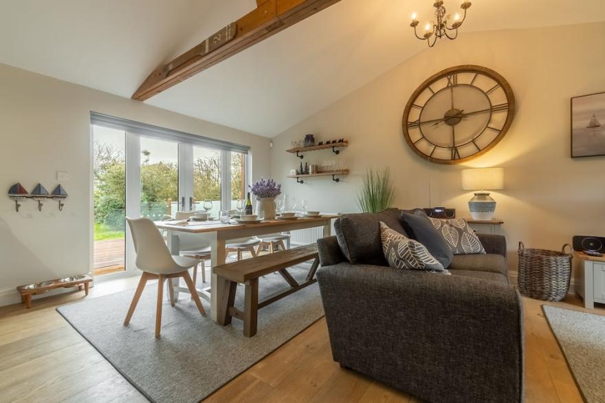 A superb wooden lodge that fits the description of a Norfolk hideaway to a tee