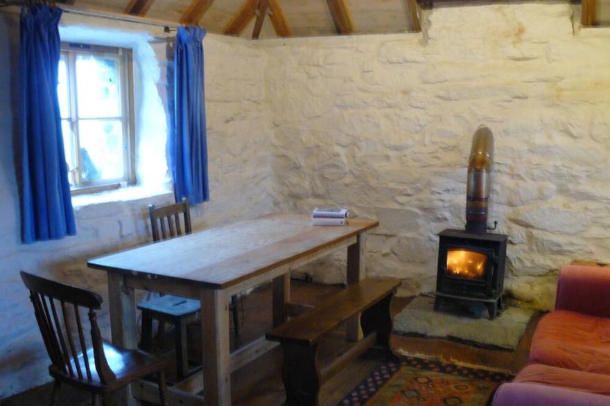 Traditional stone and thatch cottage on the waters edge with beautiful sea views