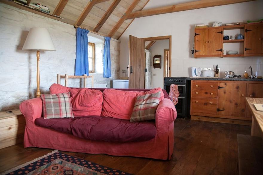 Traditional stone and thatch cottage on the waters edge with beautiful sea views