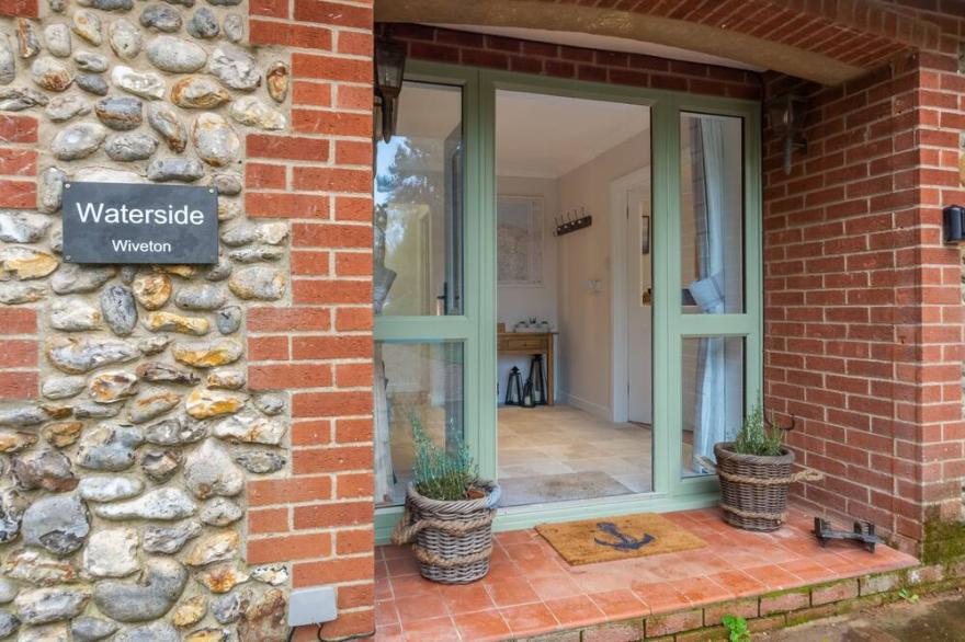 A beautiful flint fronted detached bungalow, set in glorious gardens