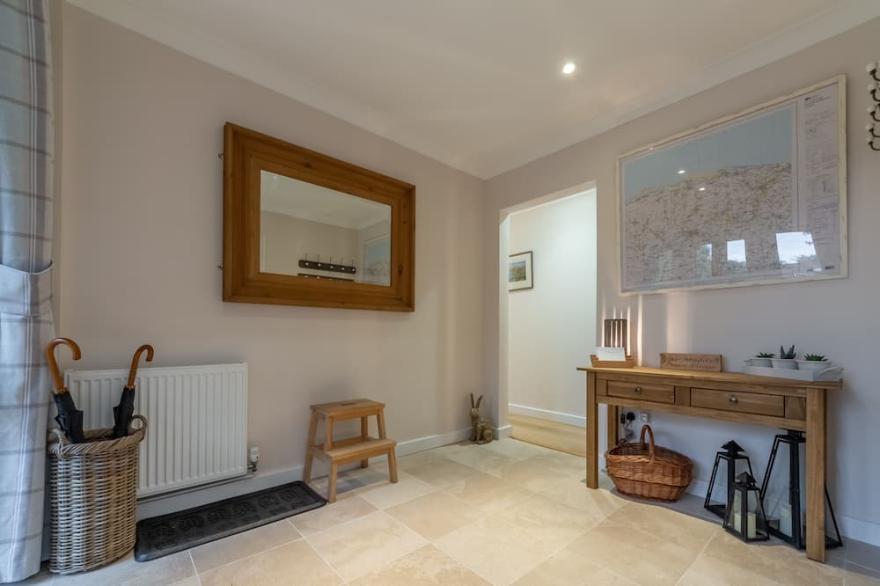 A beautiful flint fronted detached bungalow, set in glorious gardens