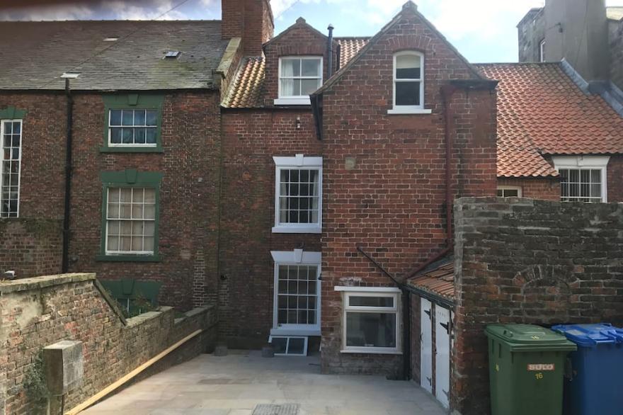 Unique old house in the heart of Whitby. Perfect location with parking .