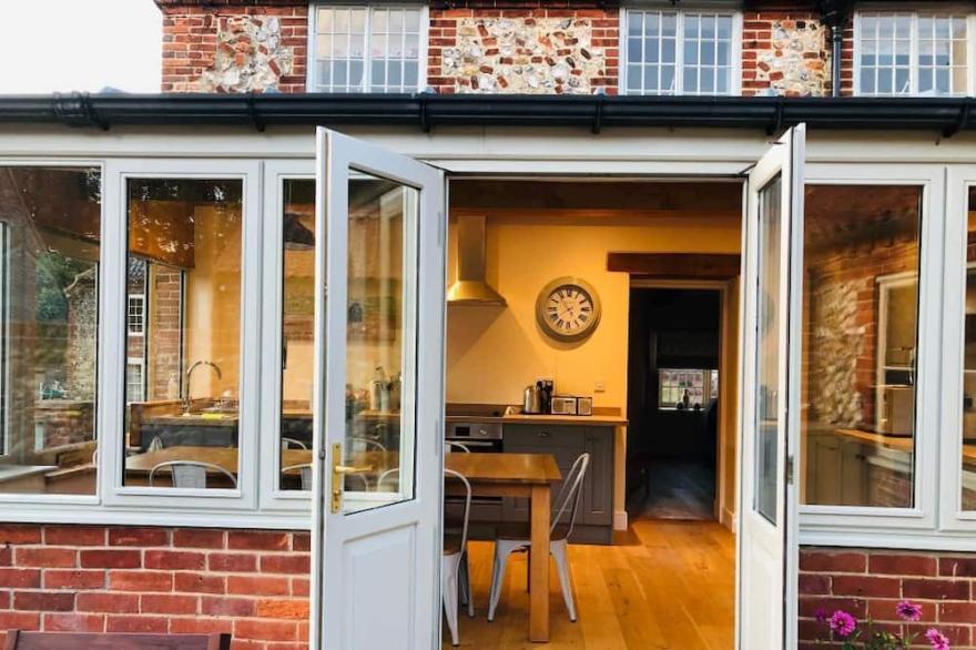 Half Moon House is a beautifully renovated brick and flint cottage near Wells.