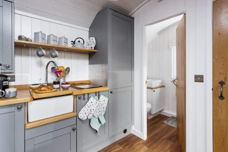 This pretty shepherds hut has been designed carefully with a king-size bed
