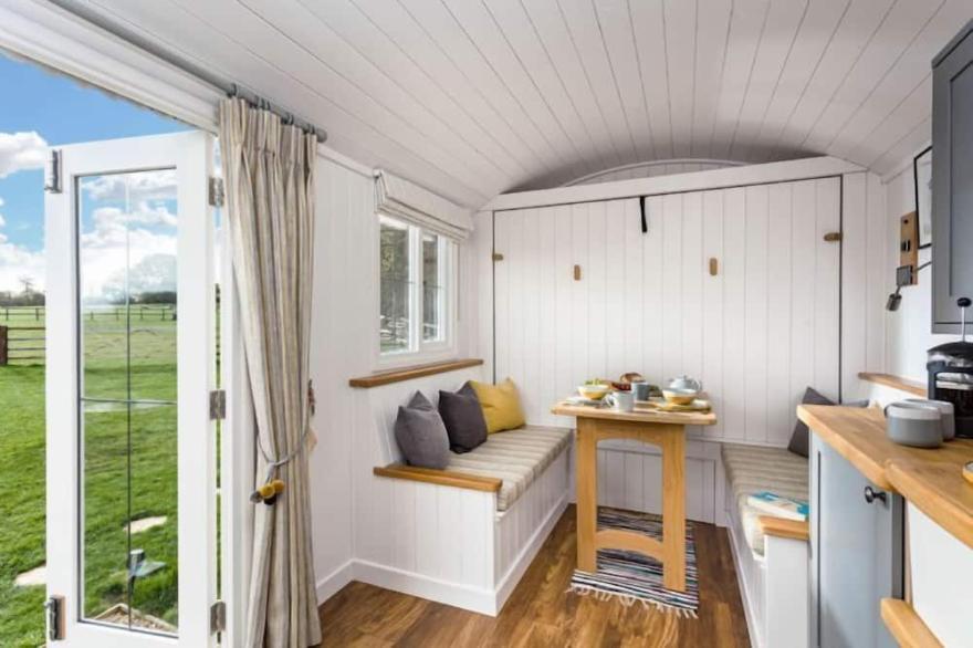 This pretty shepherds hut has been designed carefully with a king-size bed