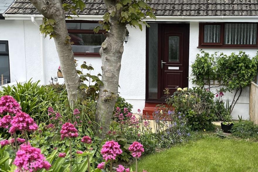 Sunnynook, a mid terrace bungalow just 500 yards from the south west coast path and sandy beaches