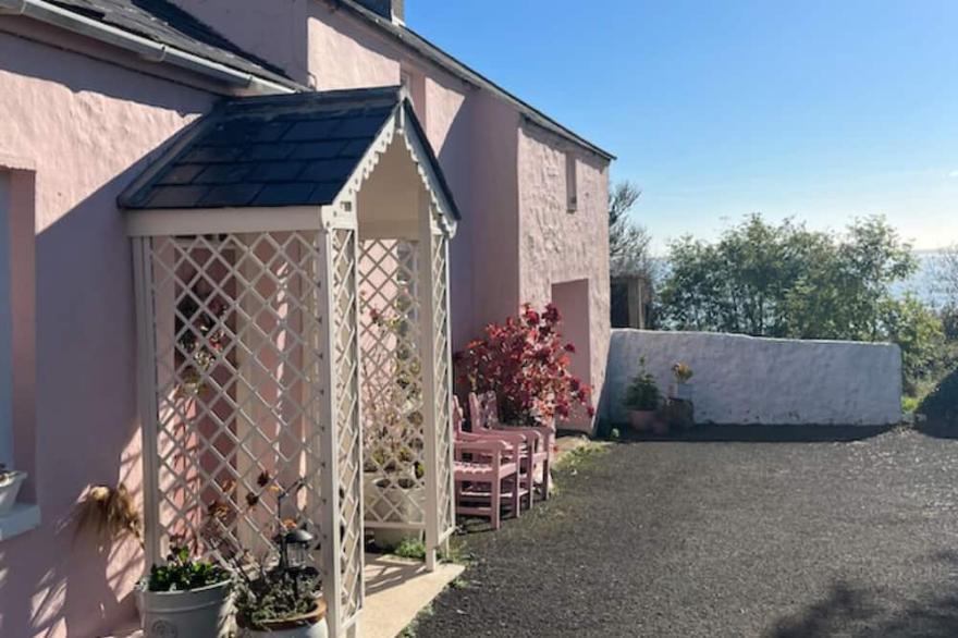 The Pink Cottage Upstairs Suite and Secret Garden... beautiful walks & sea view.