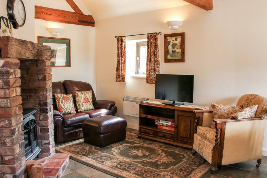 THE BYRE, character holiday cottage, with a garden in Leighton