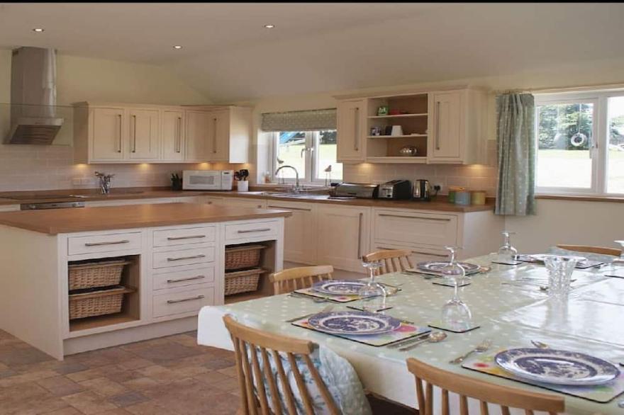 Spacious farmhouse with large childrens play area and fabulous family kitchen.