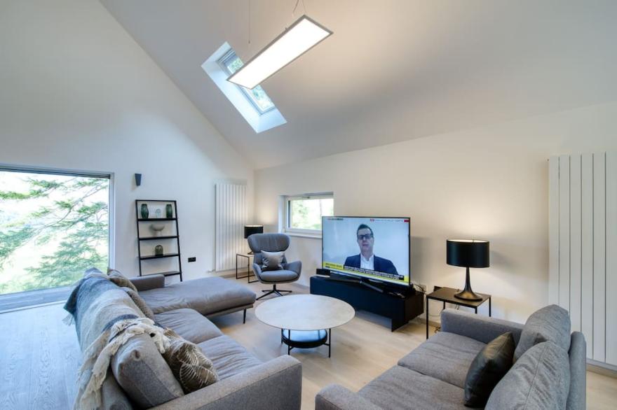 An Caisteal chalet sleeps up to 8 guests  in 4 bedrooms with loch, mountain and waterfall view.
