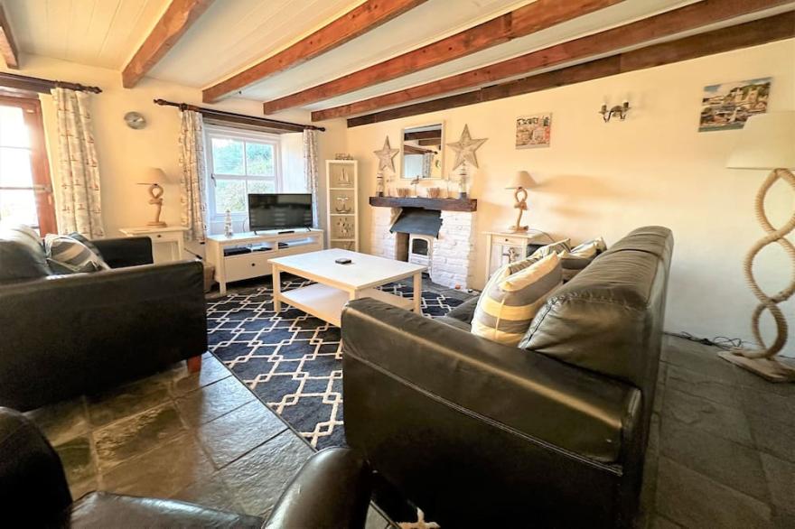 Seaweed Cottage in Fowey overlooking the beach with a garden and a parking space