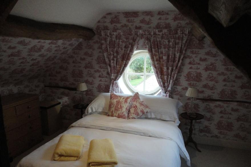 Small converted barn in peaceful village setting.
