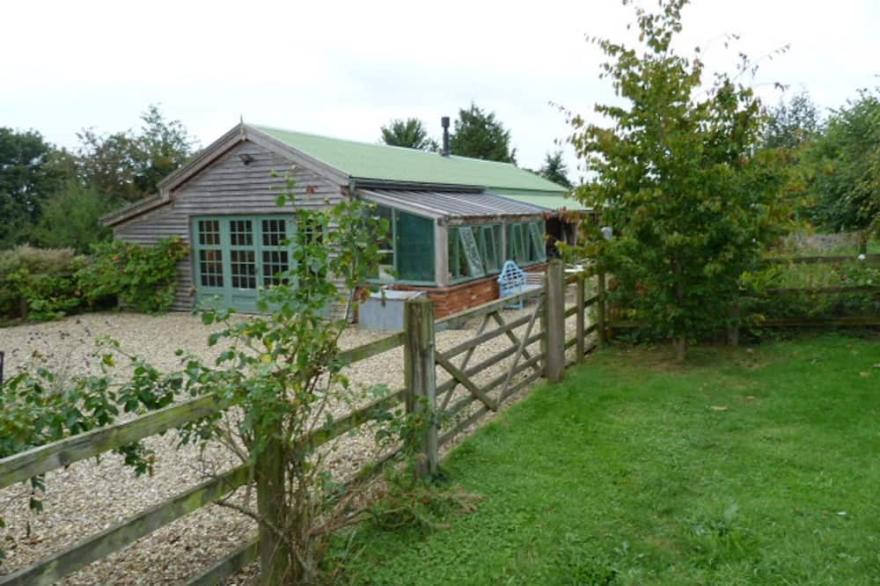 The Garden Room. Timber framed, light and airy accommodation with veranda.