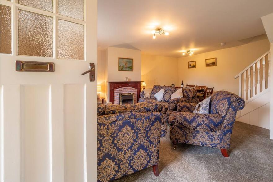 An end of terrace, farm cottage surrounded by countryside