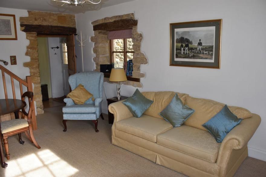 Period cottage in idyllic riverside location in prime Cotswolds village