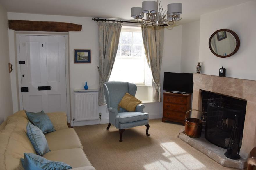 Period cottage in idyllic riverside location in prime Cotswolds village