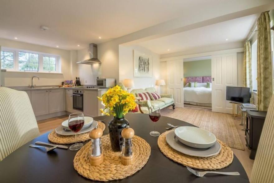 A sophisticated, contemporary ground floor apartment overlooking unspoilt views.