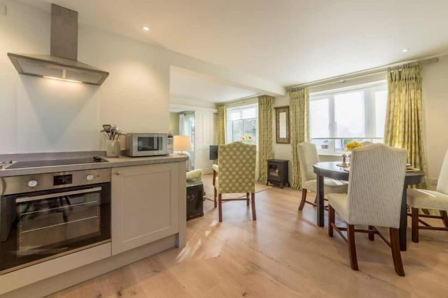 A sophisticated, contemporary ground floor apartment overlooking unspoilt views.