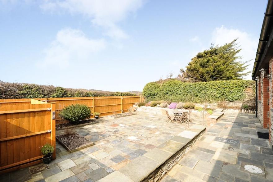 Long Linhay is a spacious cottage for 2 with sea views & private, sunny patio.