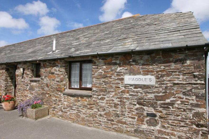 Waddles, a renovated stone cottage set around a courtyard featuring its own enclosed garden