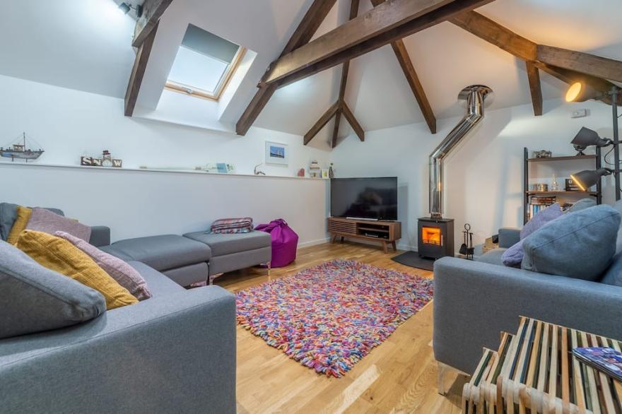 A converted barn that has been restored into a bright, modern holiday home.