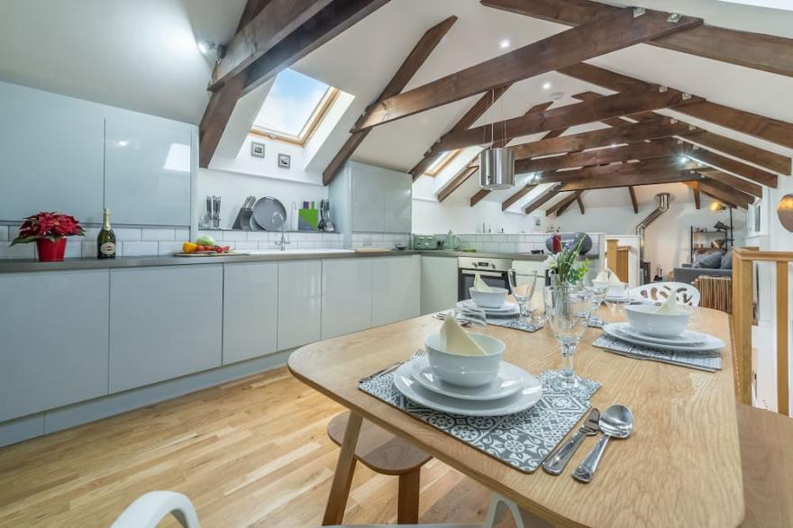 A converted barn that has been restored into a bright, modern holiday home.