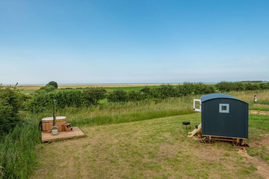 This bespoke hut is situated on the edge of the marsh with uninterrupted views out to the sea.