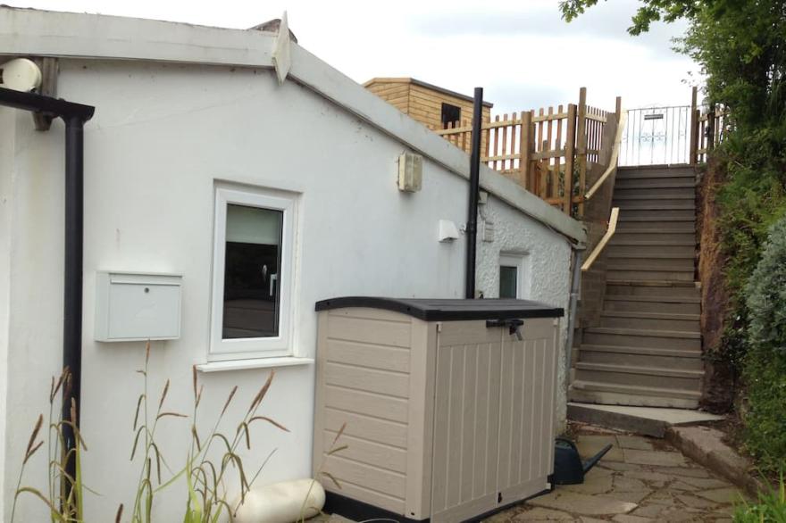 Charming cottage right on the river bank with fabulous views.