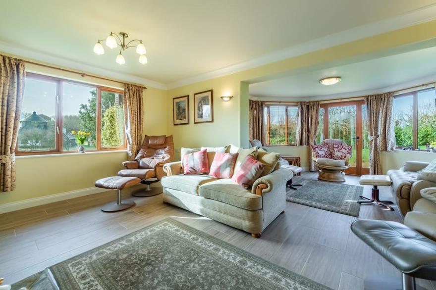 Overlooking the lakes of Roserrow, April Cottage is in an enviable location.