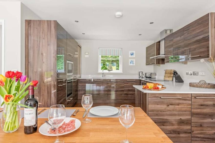 Stylish and contemporary pet friendly property featuring a wood-burning stove, patio hot tub and lar