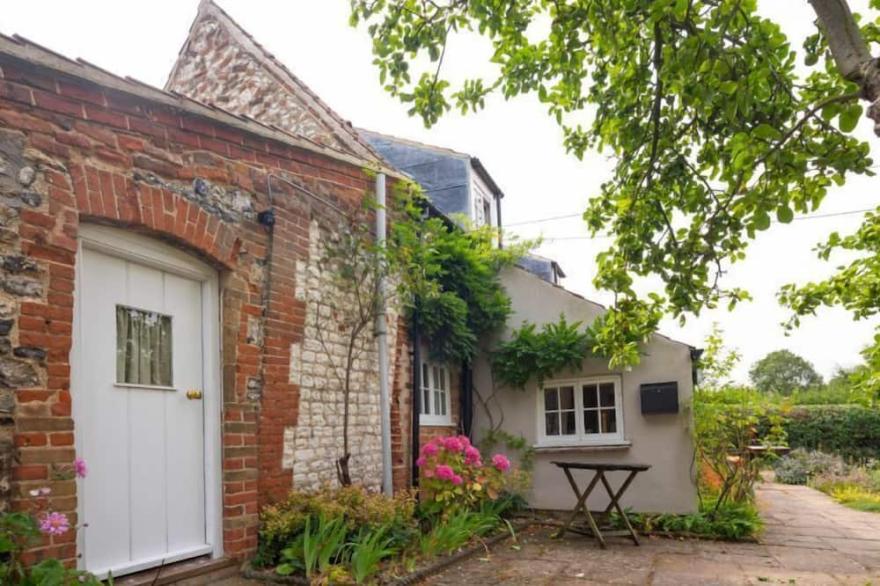 A picturesque country cottage, over 200 years old, in an idyllic rural position.