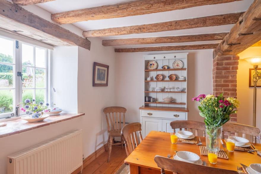 A picturesque country cottage, over 200 years old, in an idyllic rural position.