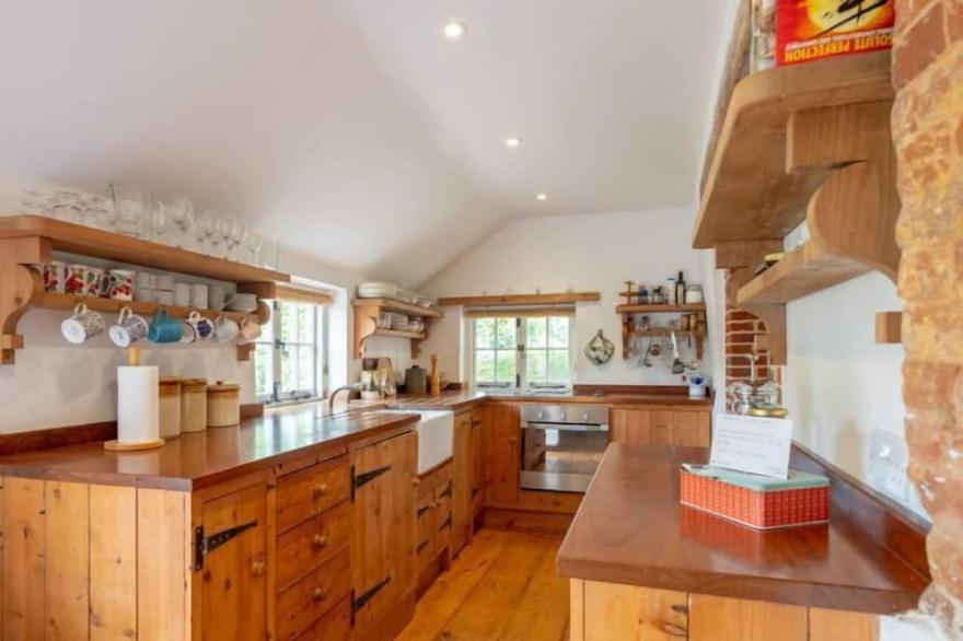 A picturesque country cottage, over 200 years old, in an idyllic rural position.