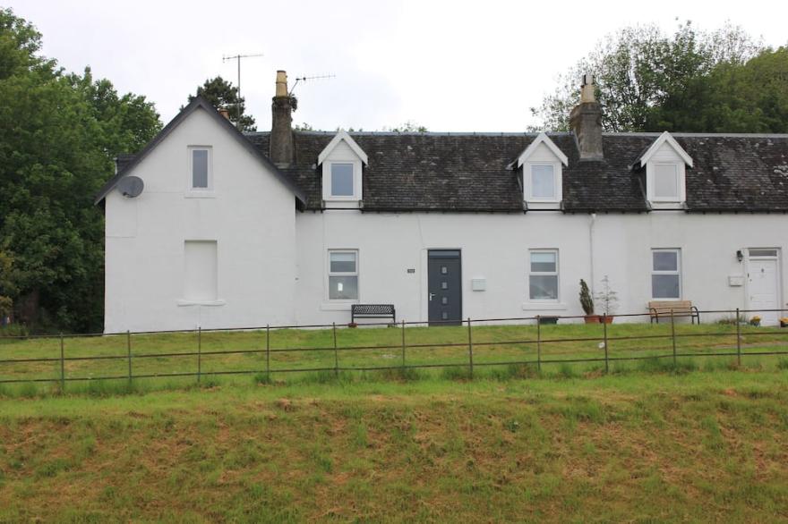Traditional whitewashed fisherman's cottage overlooking Loch Fyne