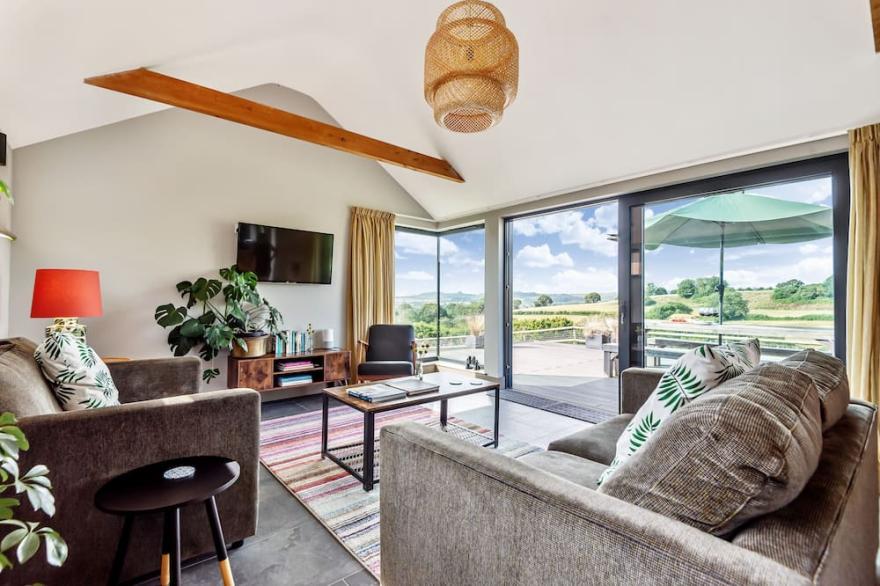 A stylish former milking parlour with outstanding rural views of Dorset.